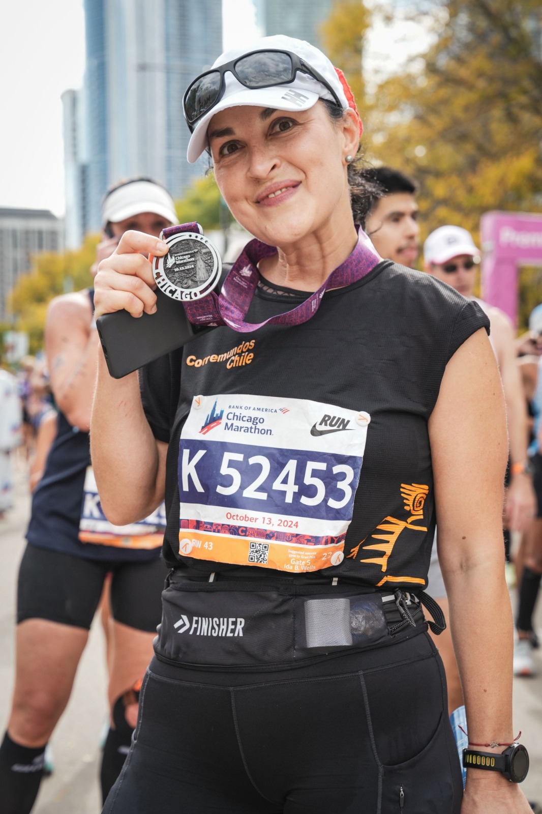 Carmen Gerea, founder of TravelTrends.io, holding her Chicago Marathon finisher medal